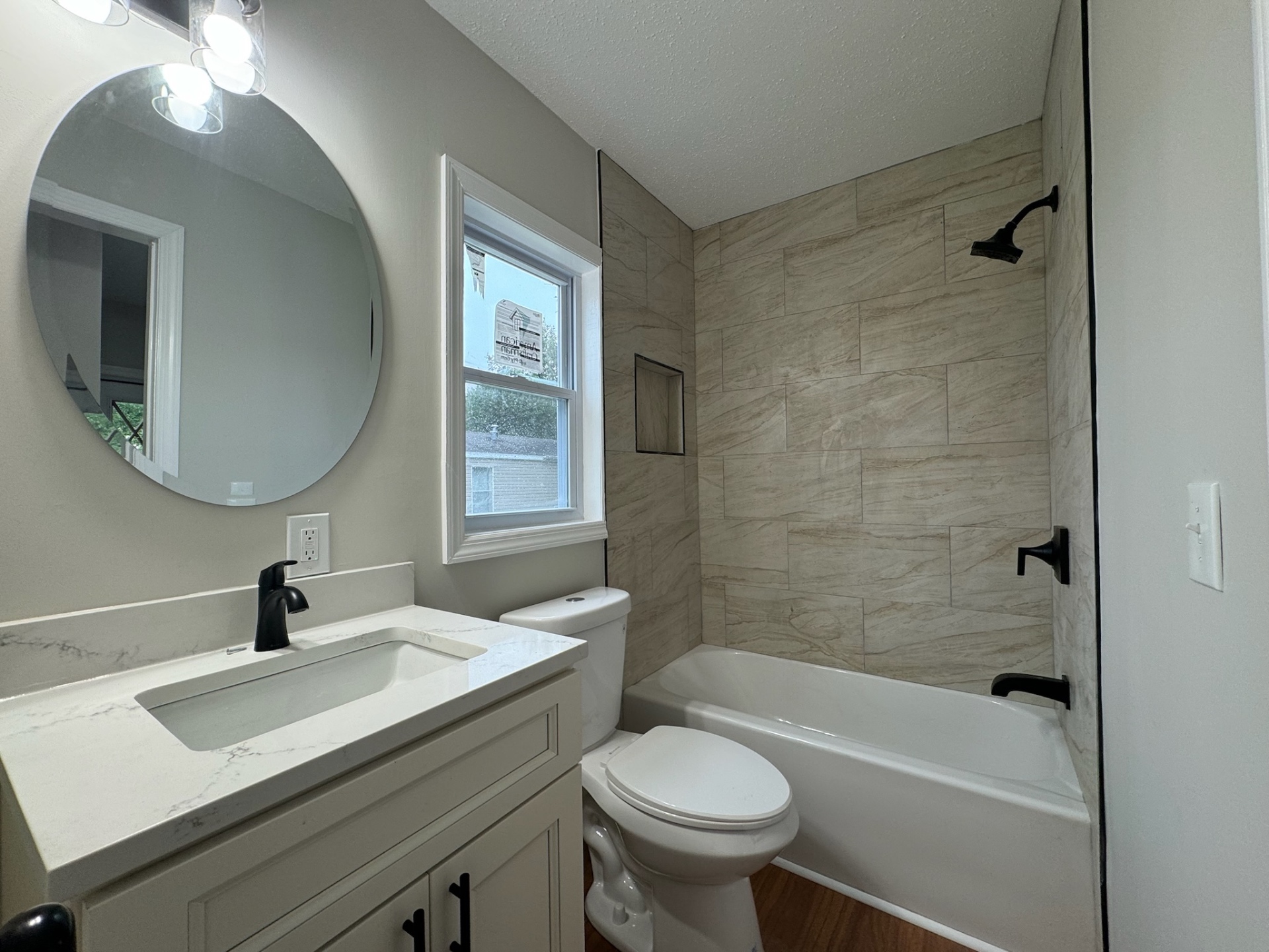 Renovated bathroom with tile tub surround and quartz vanity in Brick NJ
