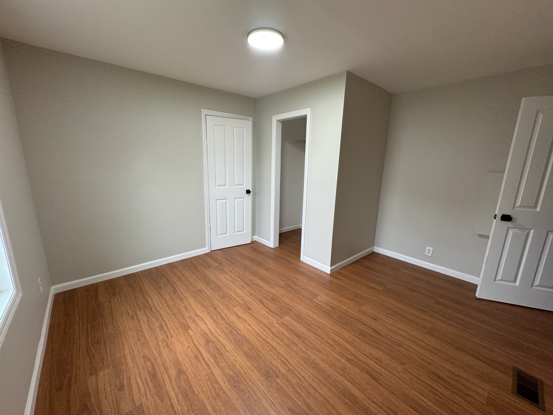 Renovated bedroom with new floors, trim, and lighting in Jackson NJ
