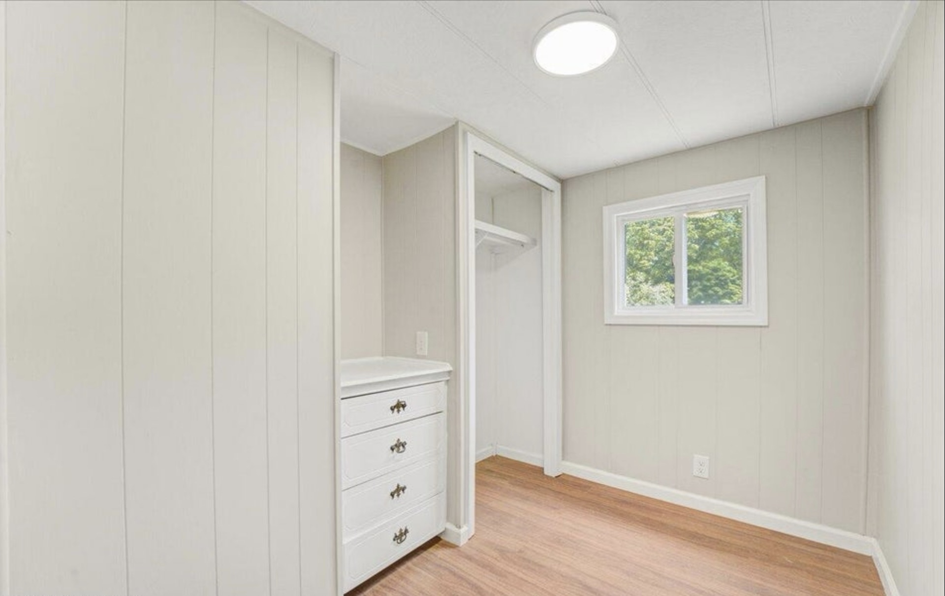 Bright small bedroom with new floors in Toms River NJ after renovation