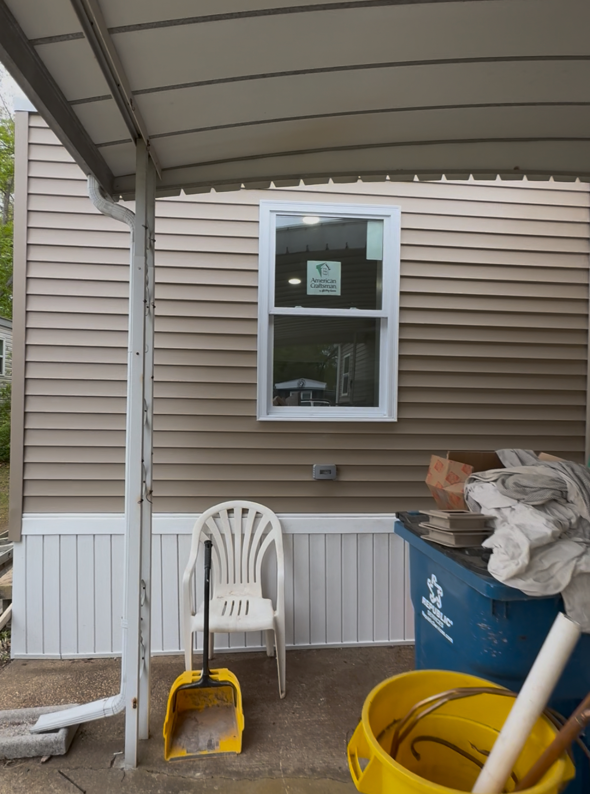 New tan vinyl siding with white skirting and new window in NJ after exterior rebuild