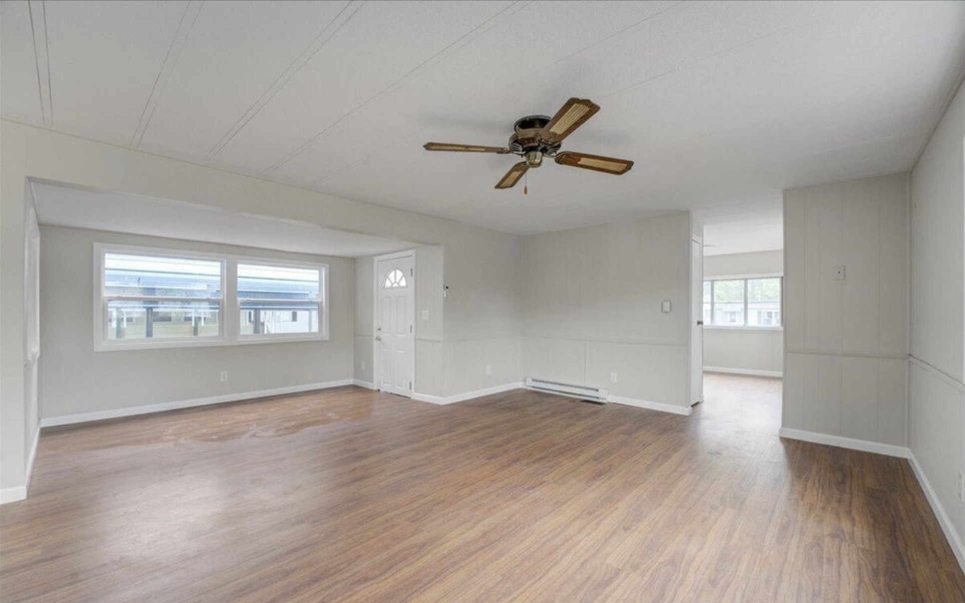 Bright open living room with new wood floors after paneling makeover in Red Bank NJ