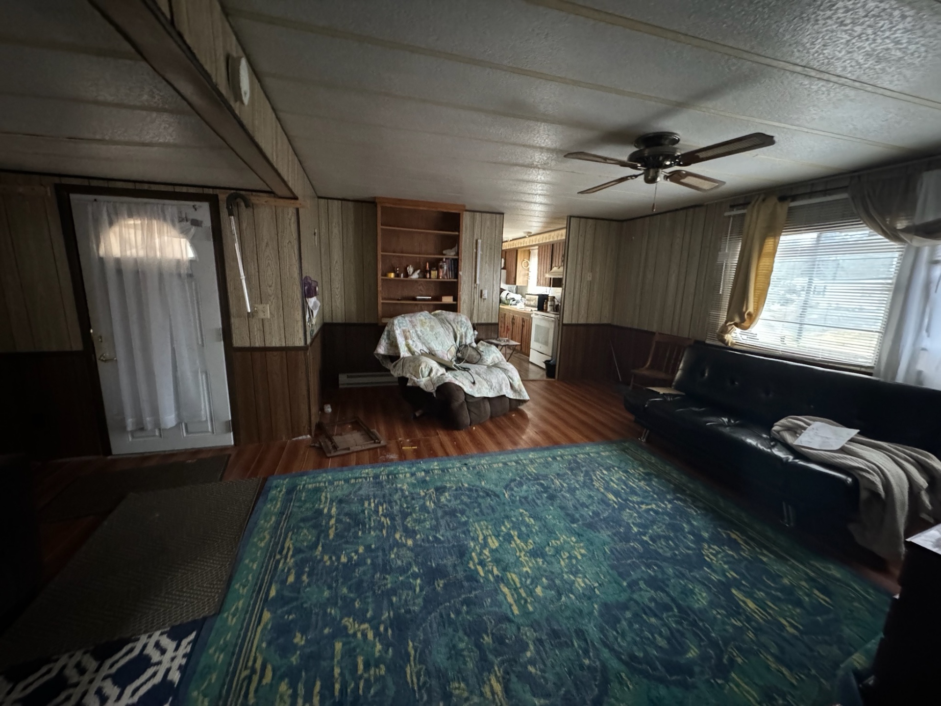 Dark wood-paneled living room in Red Bank NJ before renovation